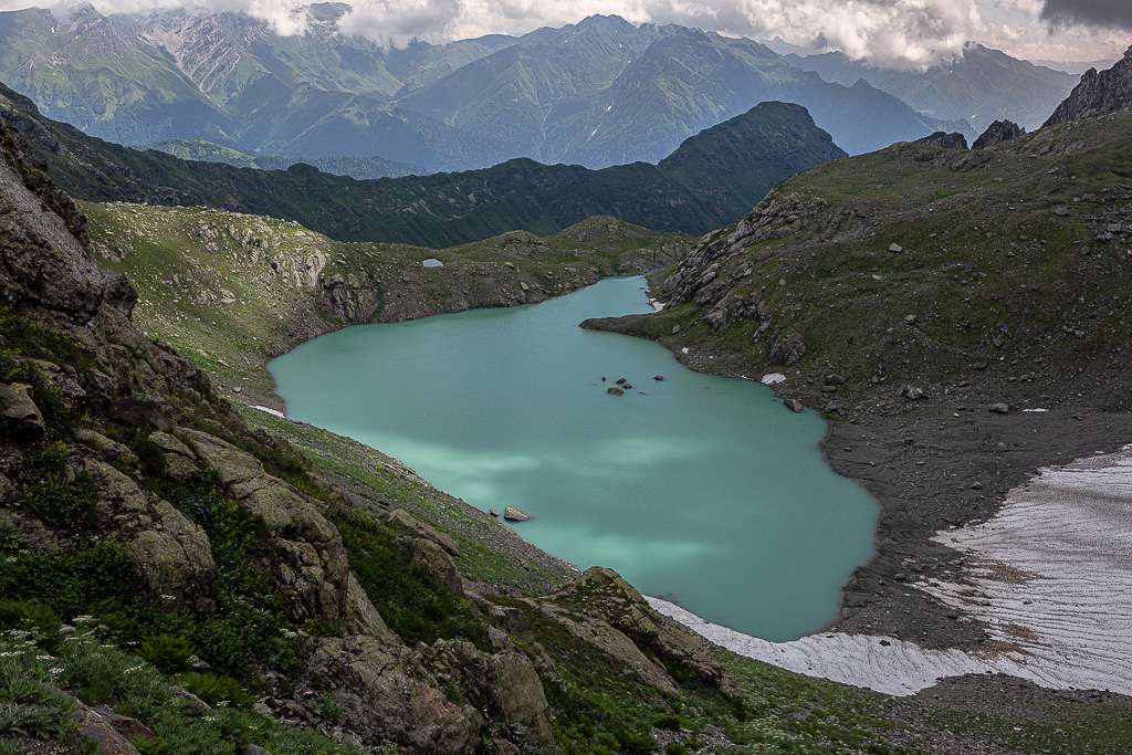 A turquoise mountain lake surrounded by rocky slopes